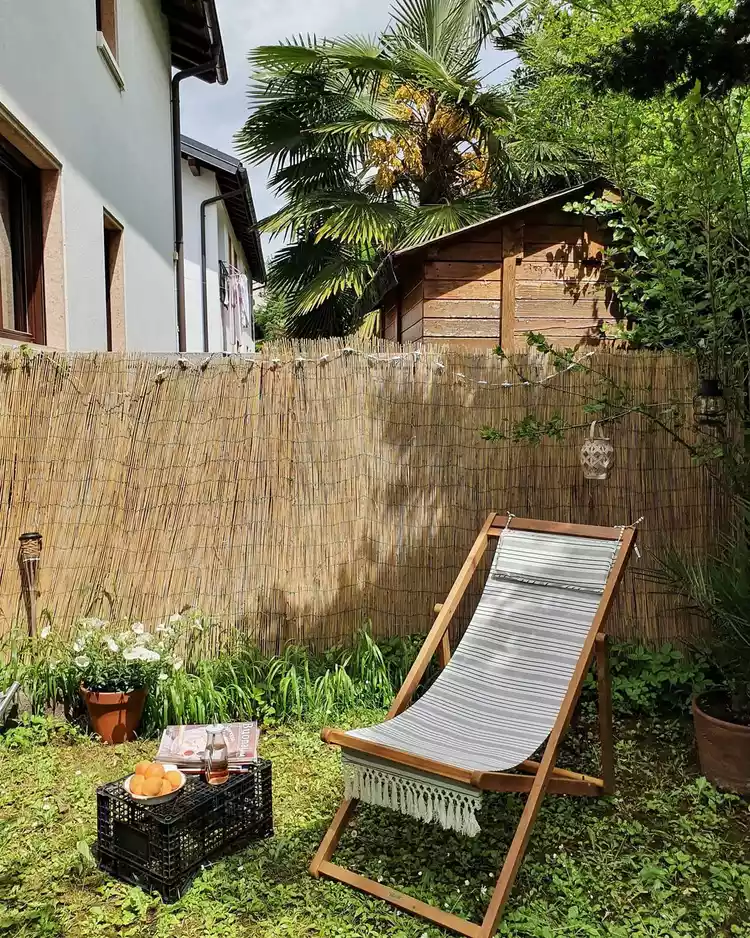 Folding outdoor lounge chair with crate as side table.