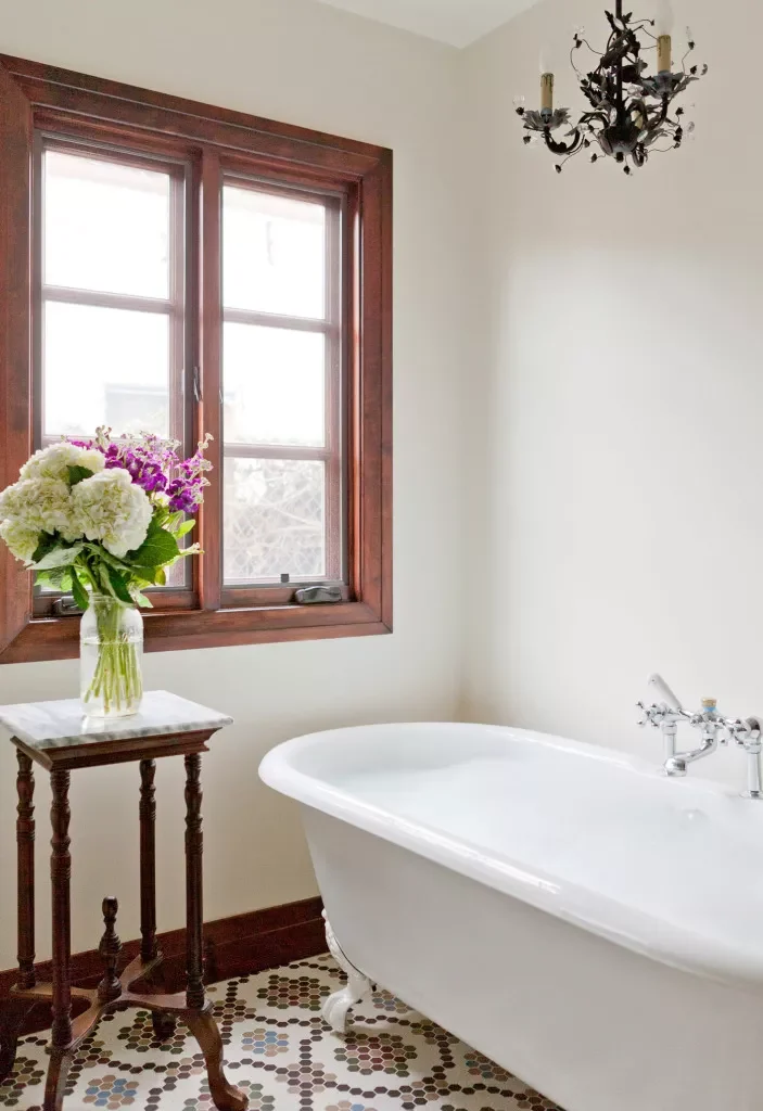 Vintage bathroom with penny tile floor and clawfoot bathtub - Katherine Carter