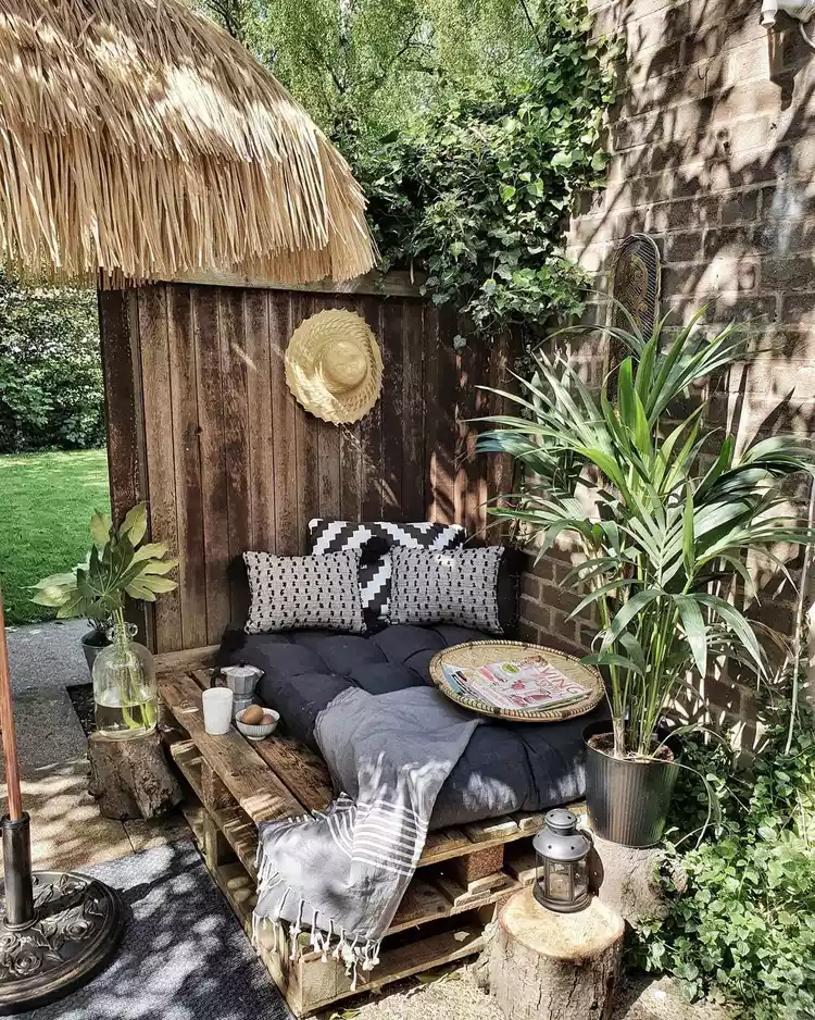 Outdoor nook with daybed and plants.