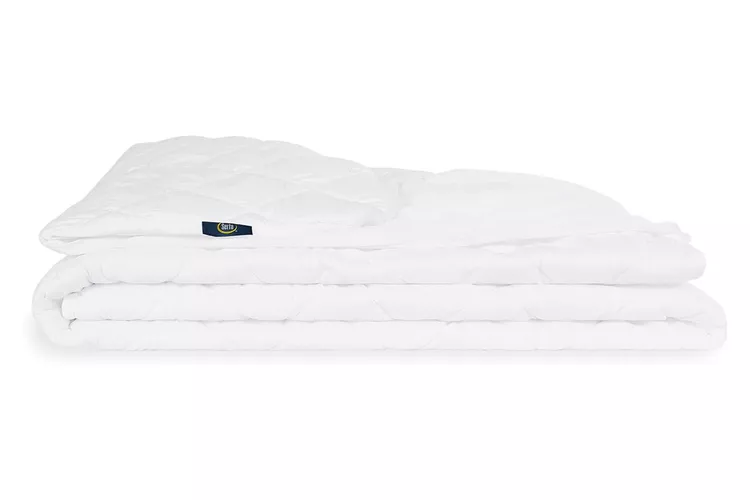 Serta Power Clean quilted waterproof mattress pad on a bed