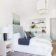 A boho bedroom with large bed with pillows and a shelf