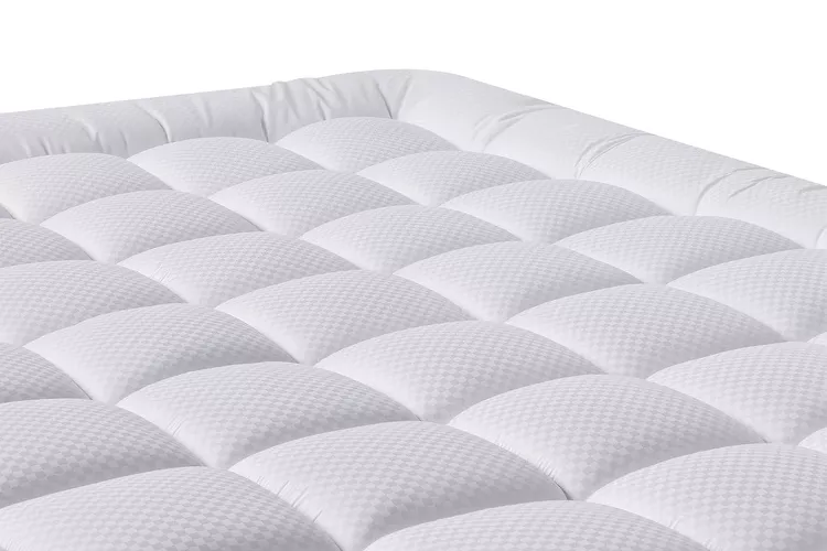 Matbeby quilted mattress pad fitted over a mattress