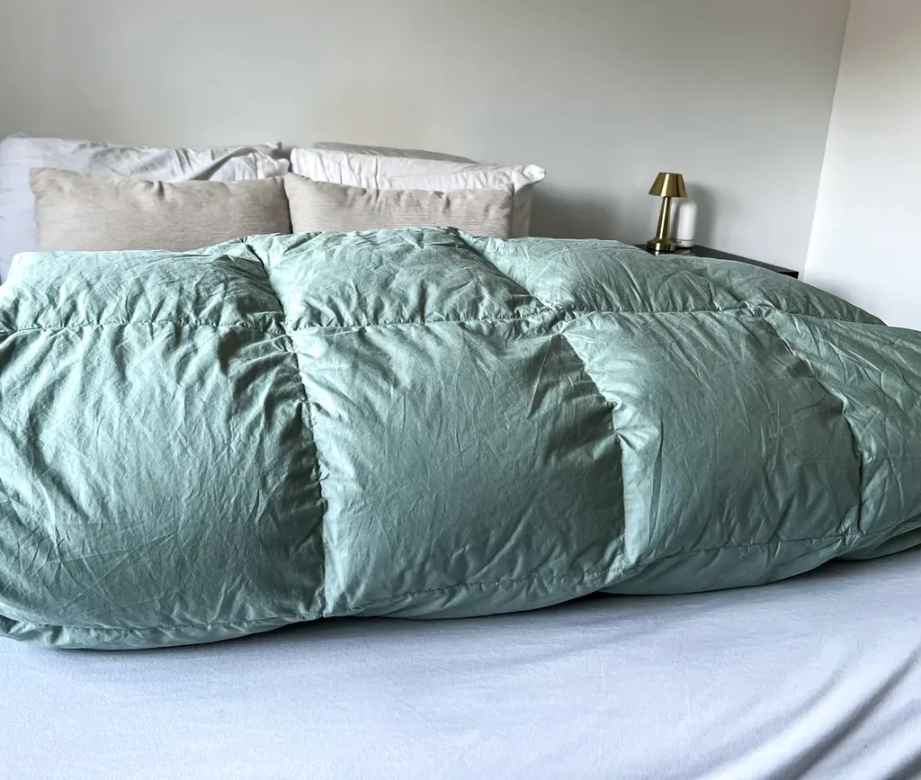 The Company Store LaCrosse light warmth down comforter on a bed